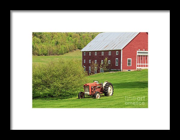 Photograph of an old vintage red tractor and barn framed