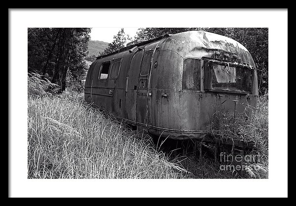 An old abandoned Airstream travel trailer in the rain forest of Hawaii
